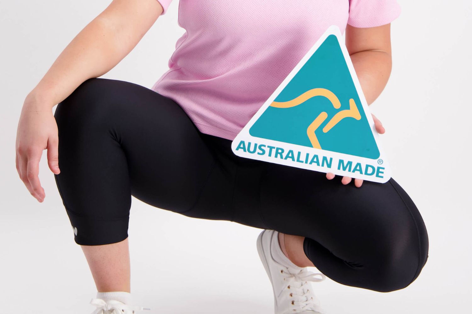woman in Cycling apparel holding Australian Made sign