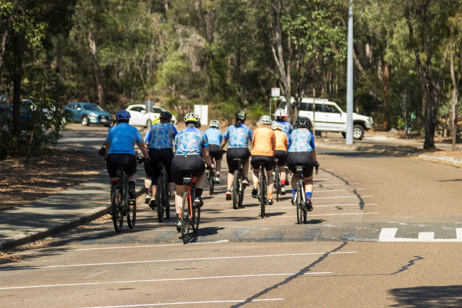 group of female cyclists riding on the road