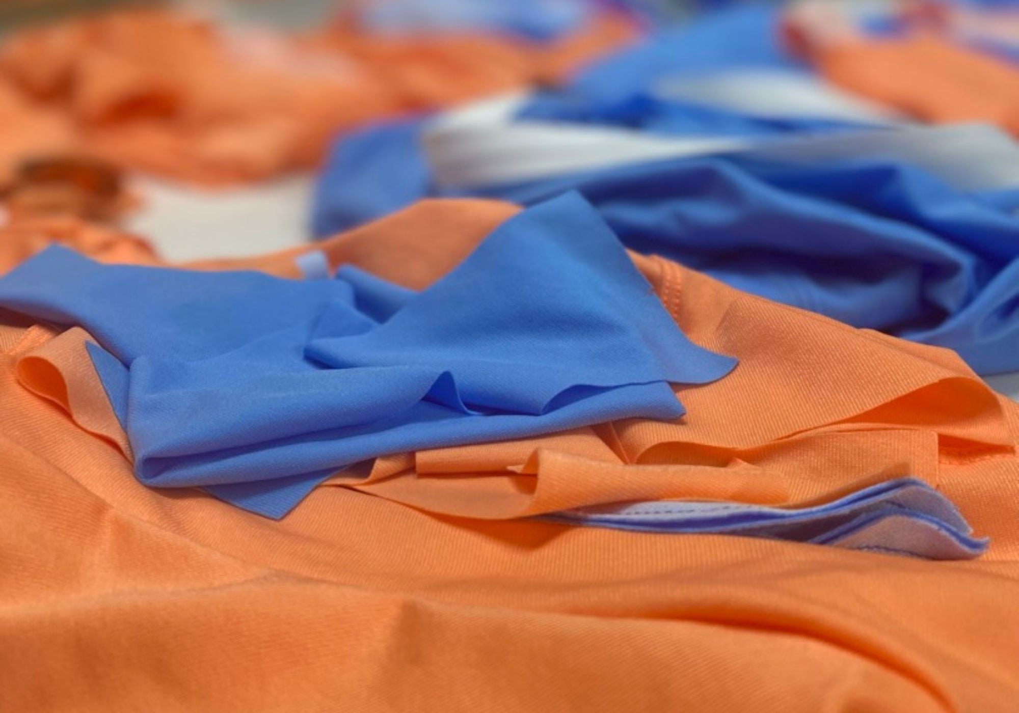 Stack of blue and orange fabric sheets with a blurred background