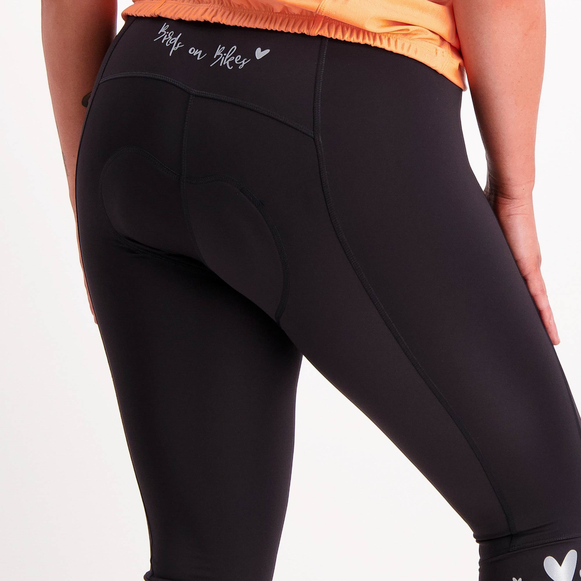 close up of black 3/4 length padded bike pants
