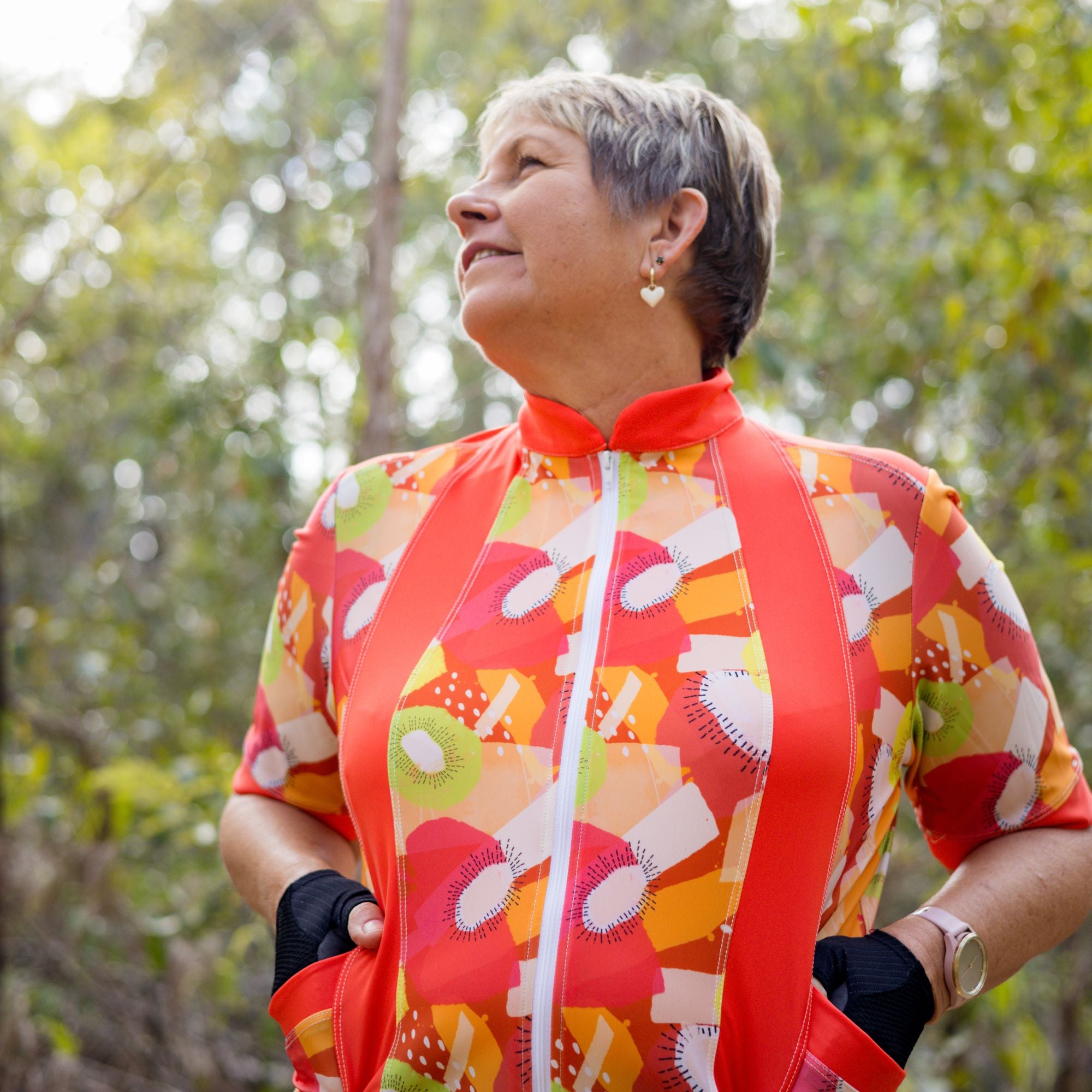 Lifestyle shot of cyclist wearing Carefree Cycling Jersey in Tutti Fruity orange print