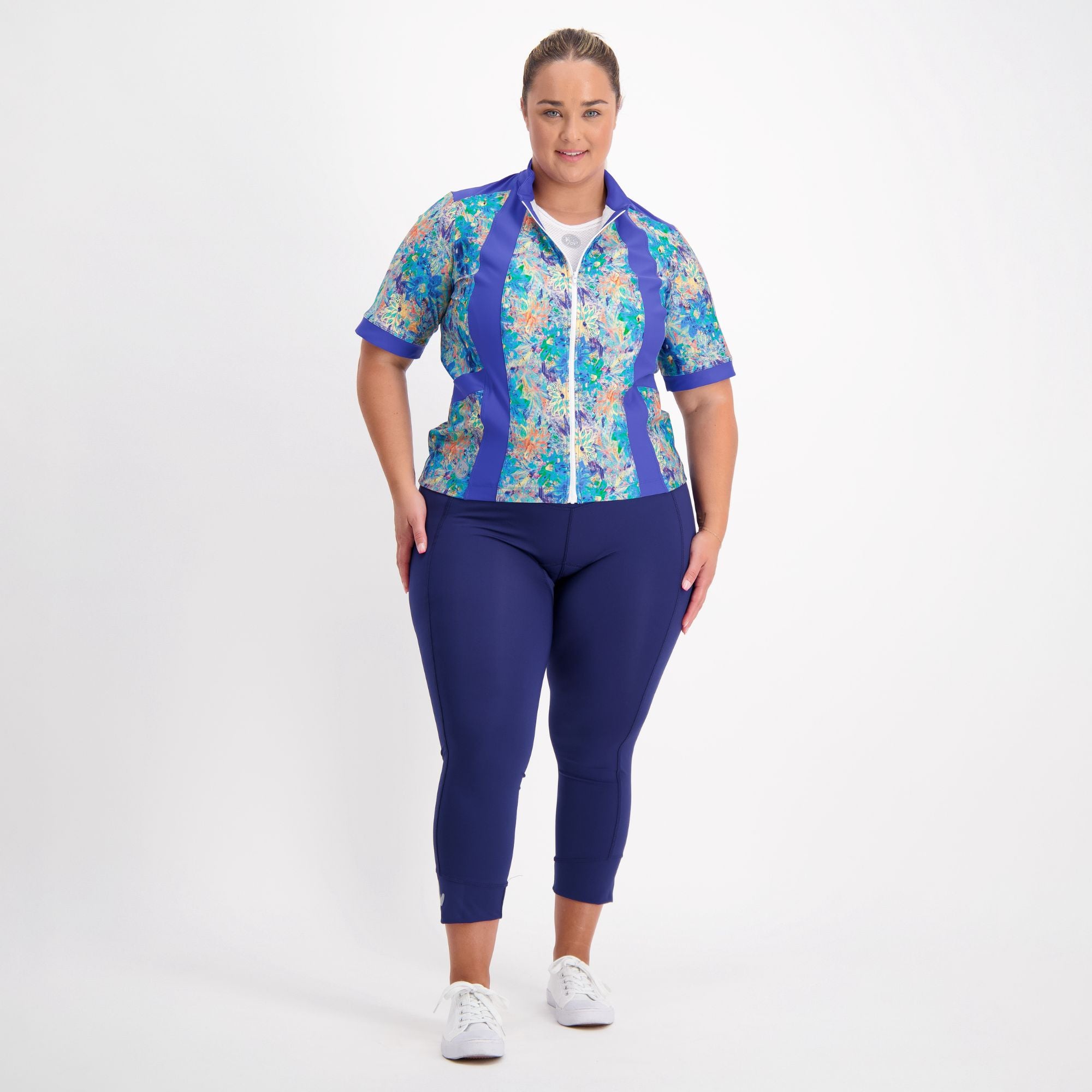 Full body view of model wearing the blue artsy floral carefree cycling jersey