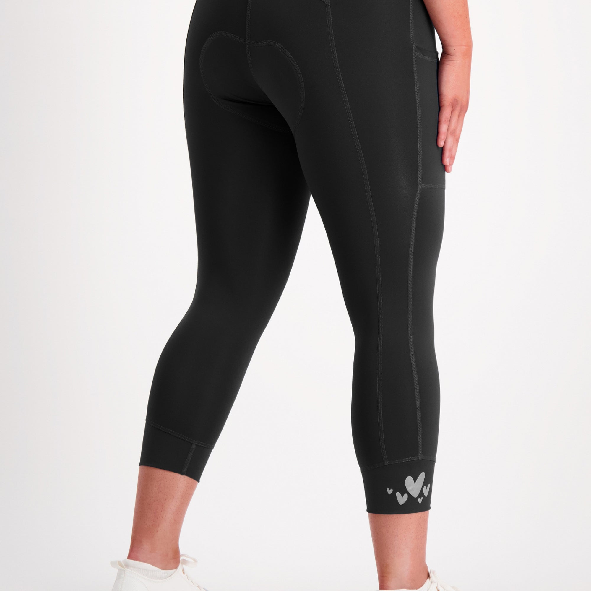 Black capri padded bike leggings with a brand logo on a white background