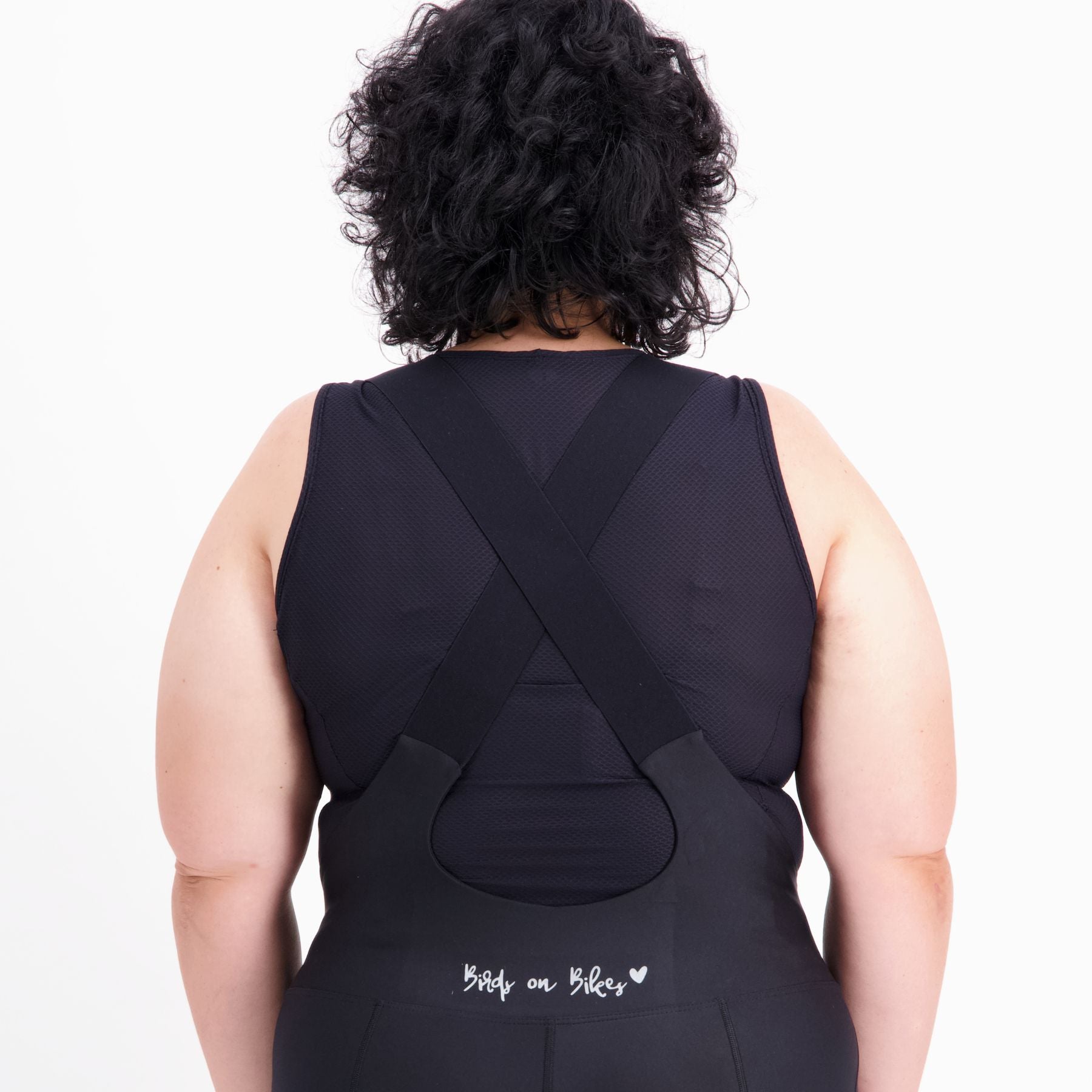 Back view of black mesh base layer with longline hem