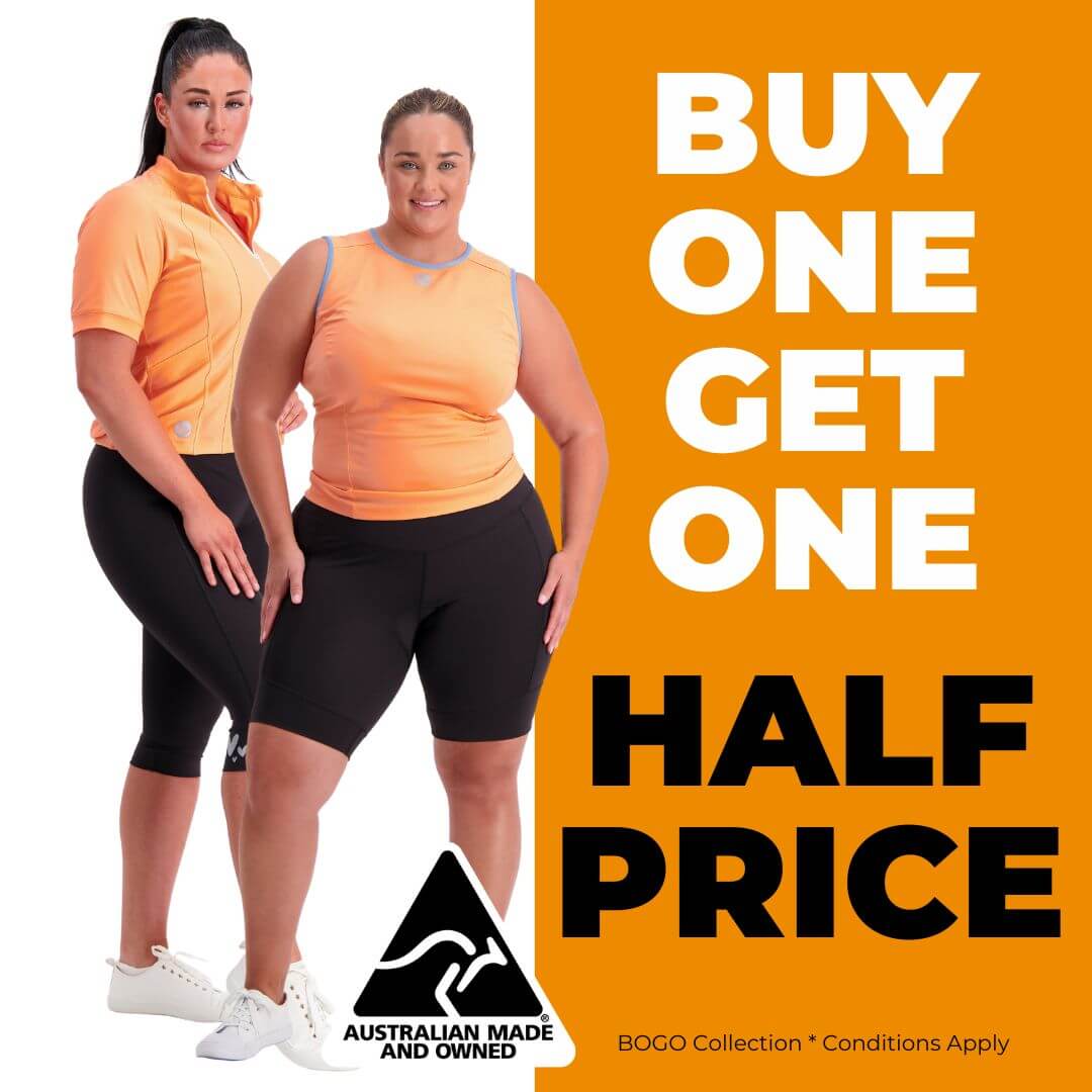 Two women wearing matching cycling wear with a promotional message on an orange background.