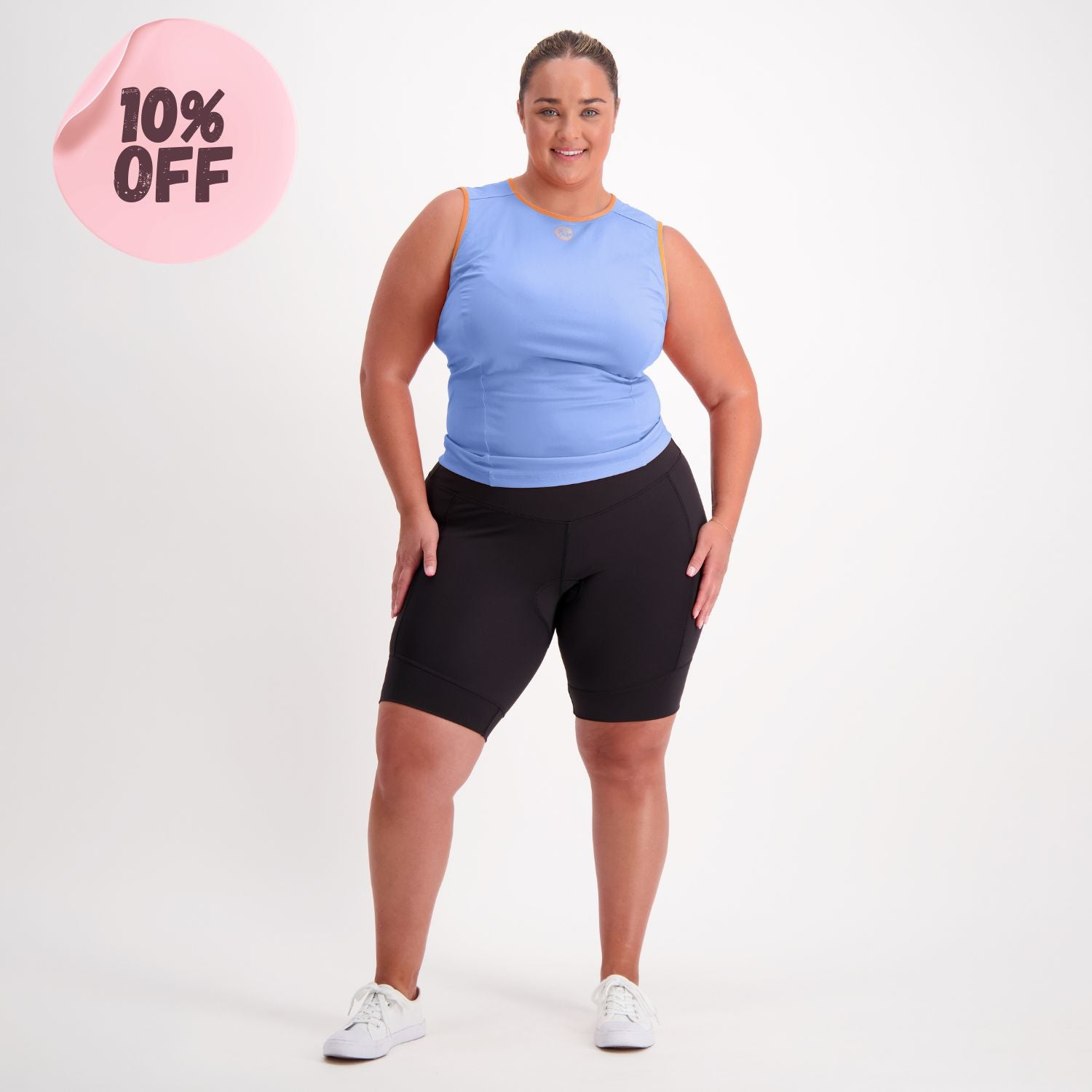 curvy female cyclist in a blue base layer and black padded bike pants