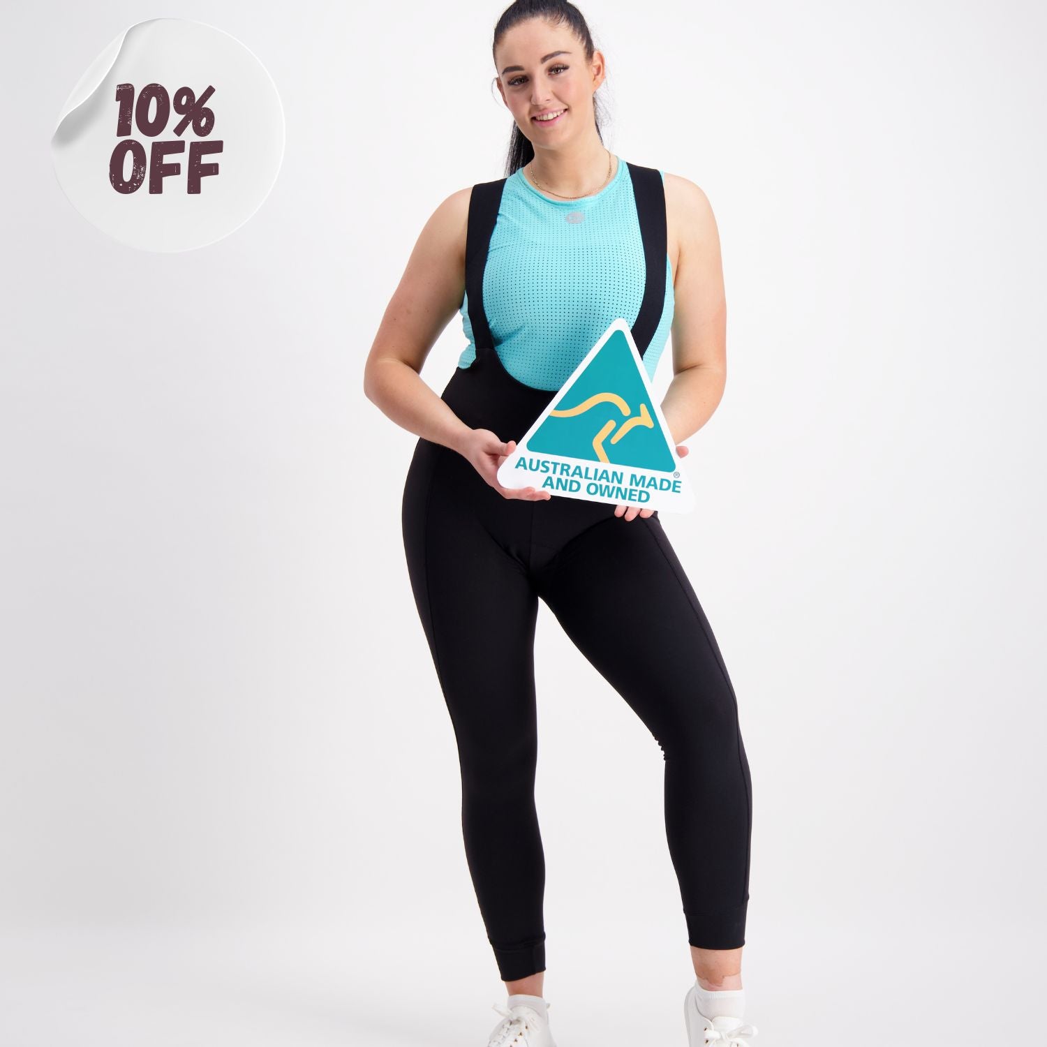 female cyclist model in a base layer and long bib tights holding Australian Made sign