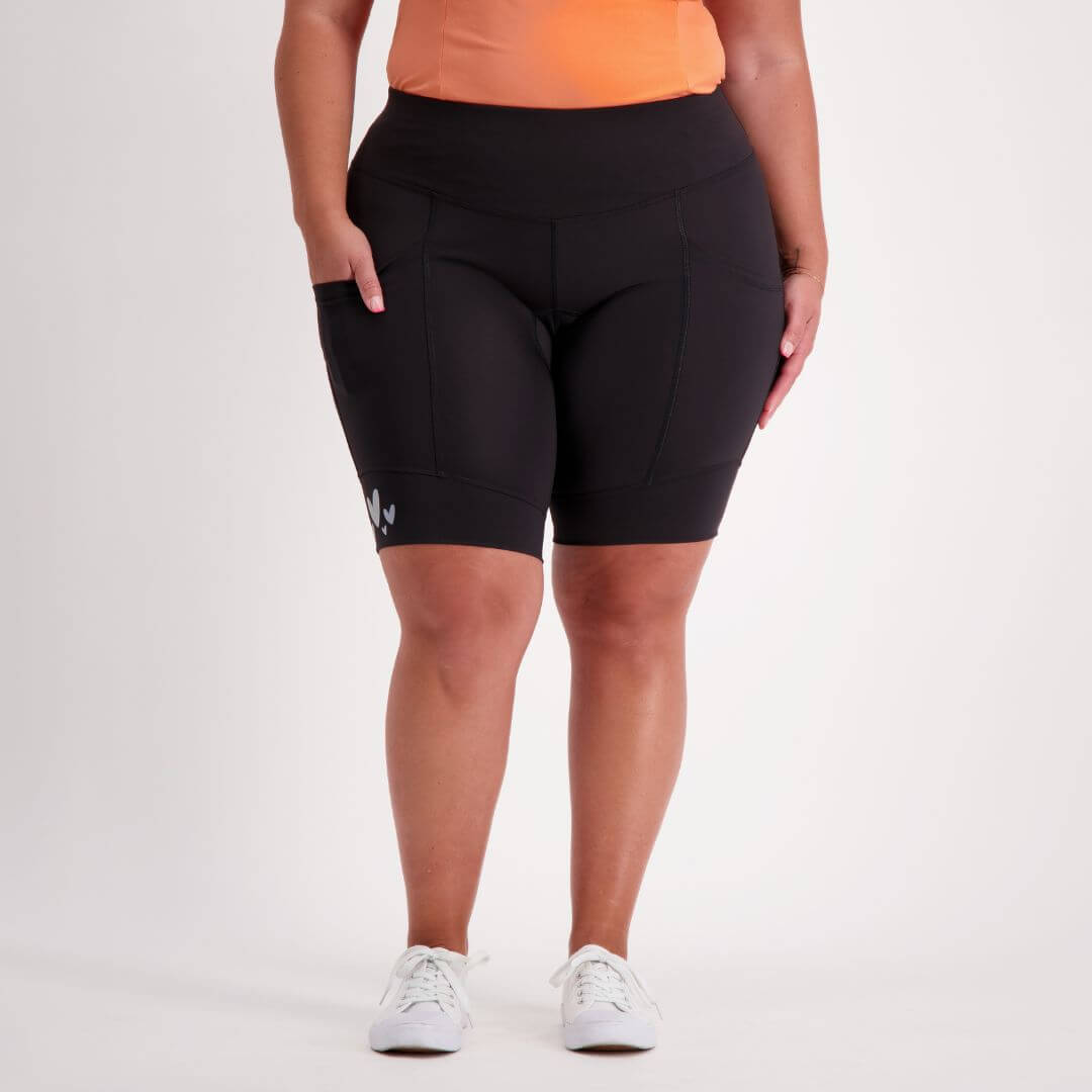 Person wearing black padded cycling shorts on a white background