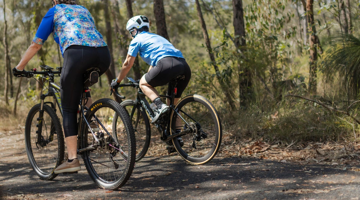 women cyclists riding on bush track wearing womens cycling shorts