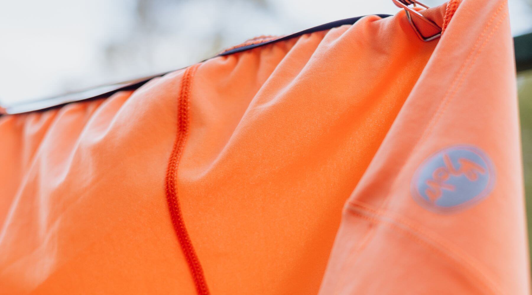 orange cycling jersey on a clothes line