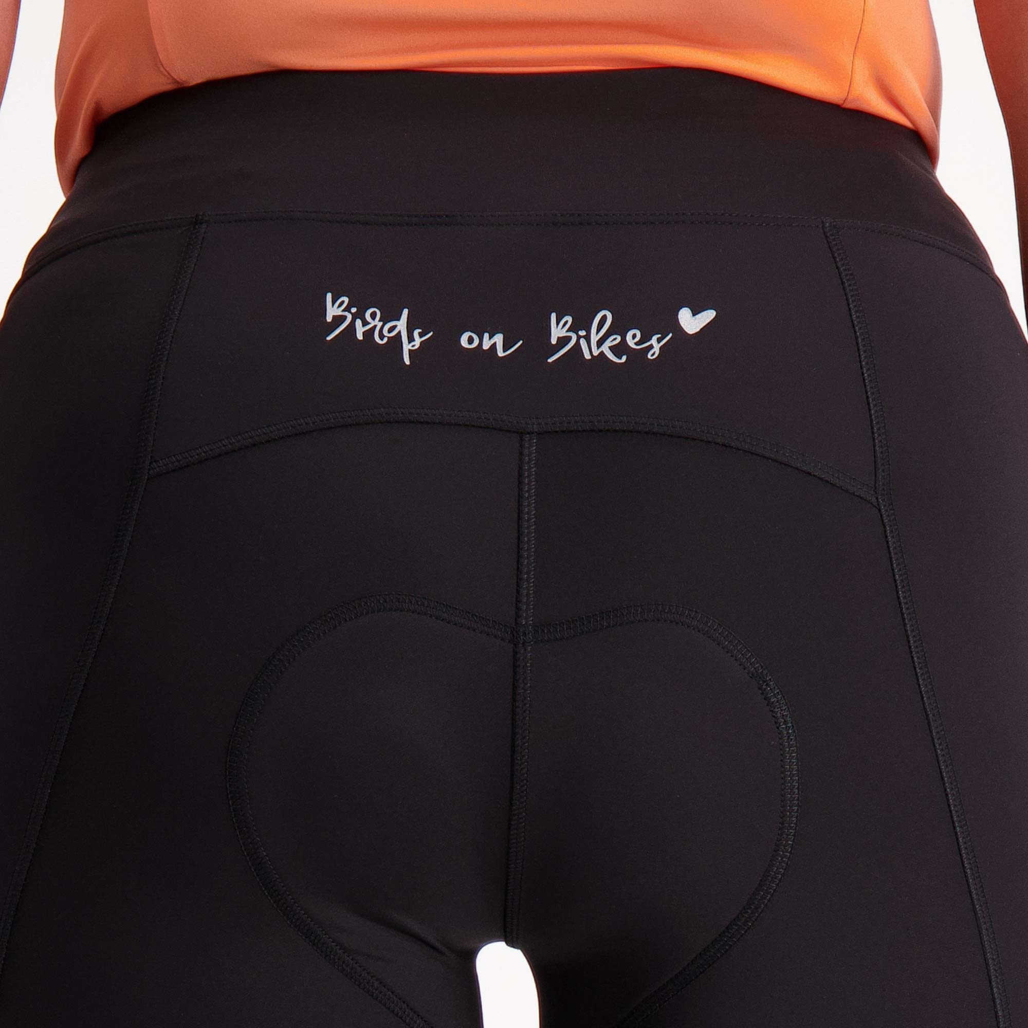 close up of back waistband  on black 3/4 length padded bike pants