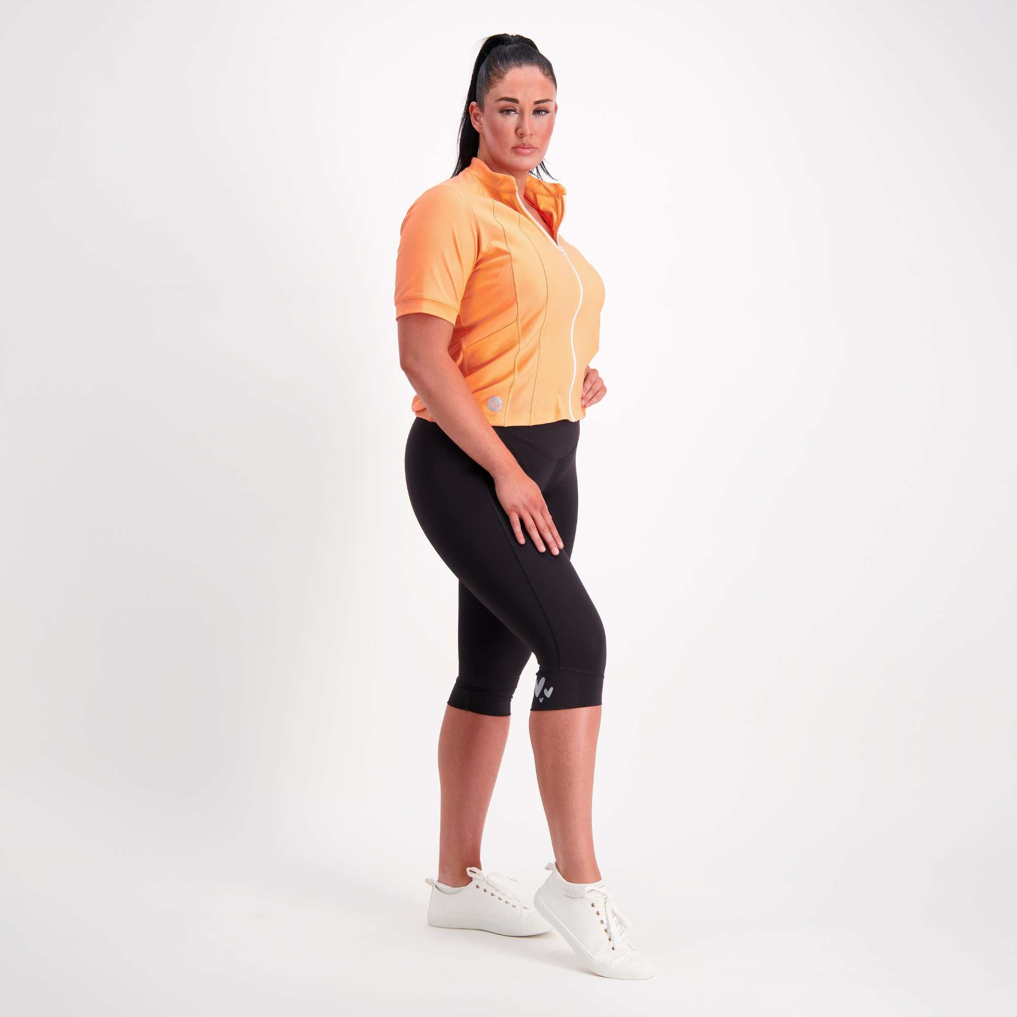 Orange short sleeve women's cycling jersey full body view on model