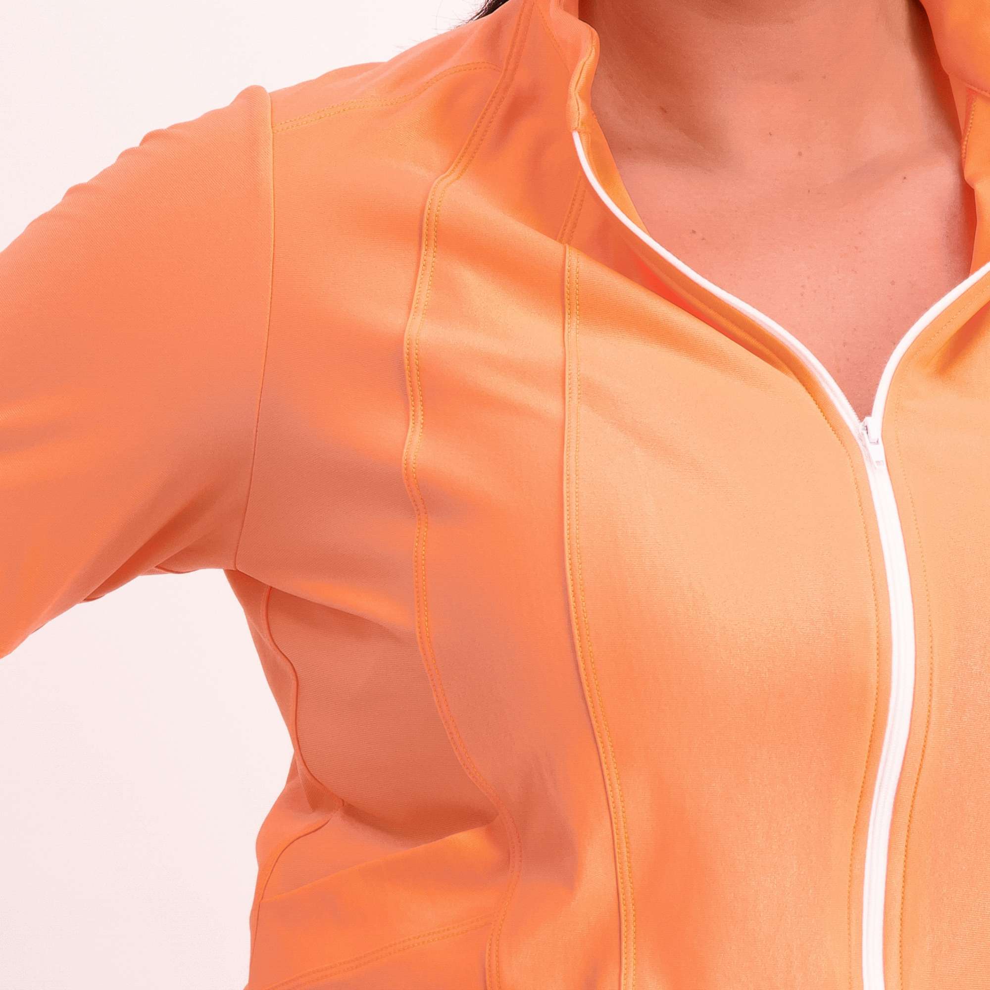 Orange short sleeve women's cycling jersey close up of zip and panels