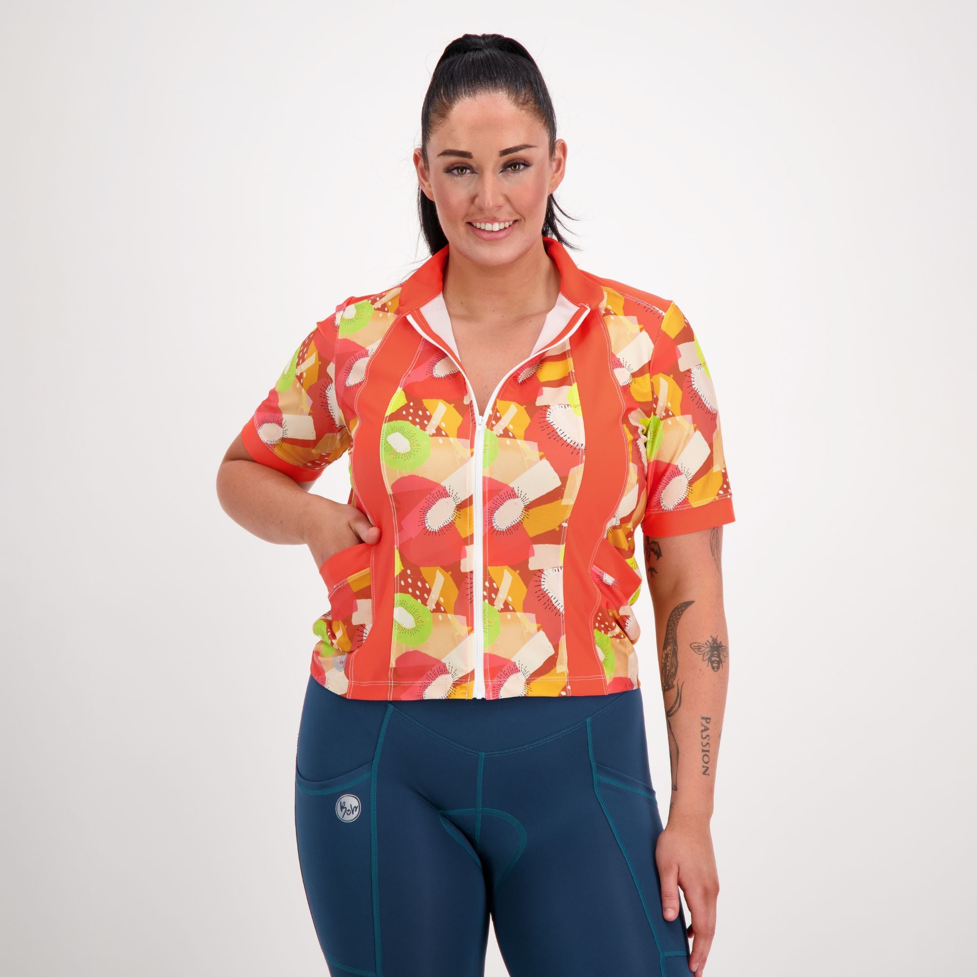 Front view of model wearing Carefree Cycling Jersey in Tutti Fruity orange print