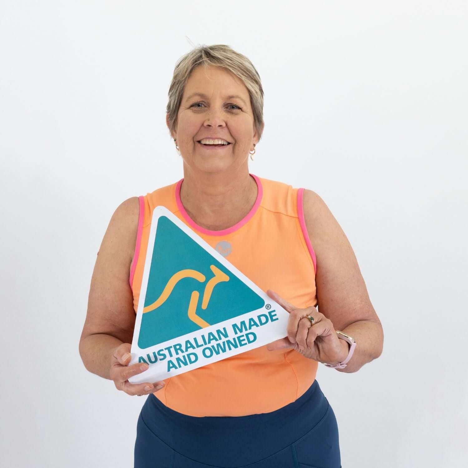 Woman holding an 'Australian Made and Owned' sign against a white background