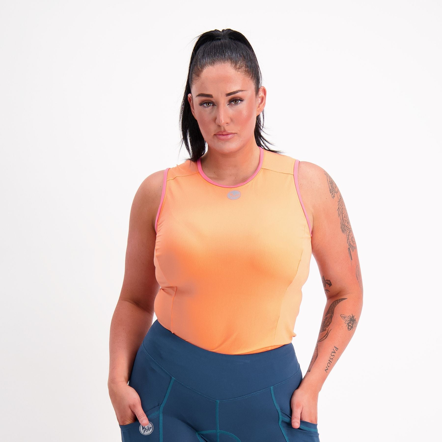 front view of Orange with pink trim sleeveless Cycling Base Layer on female model