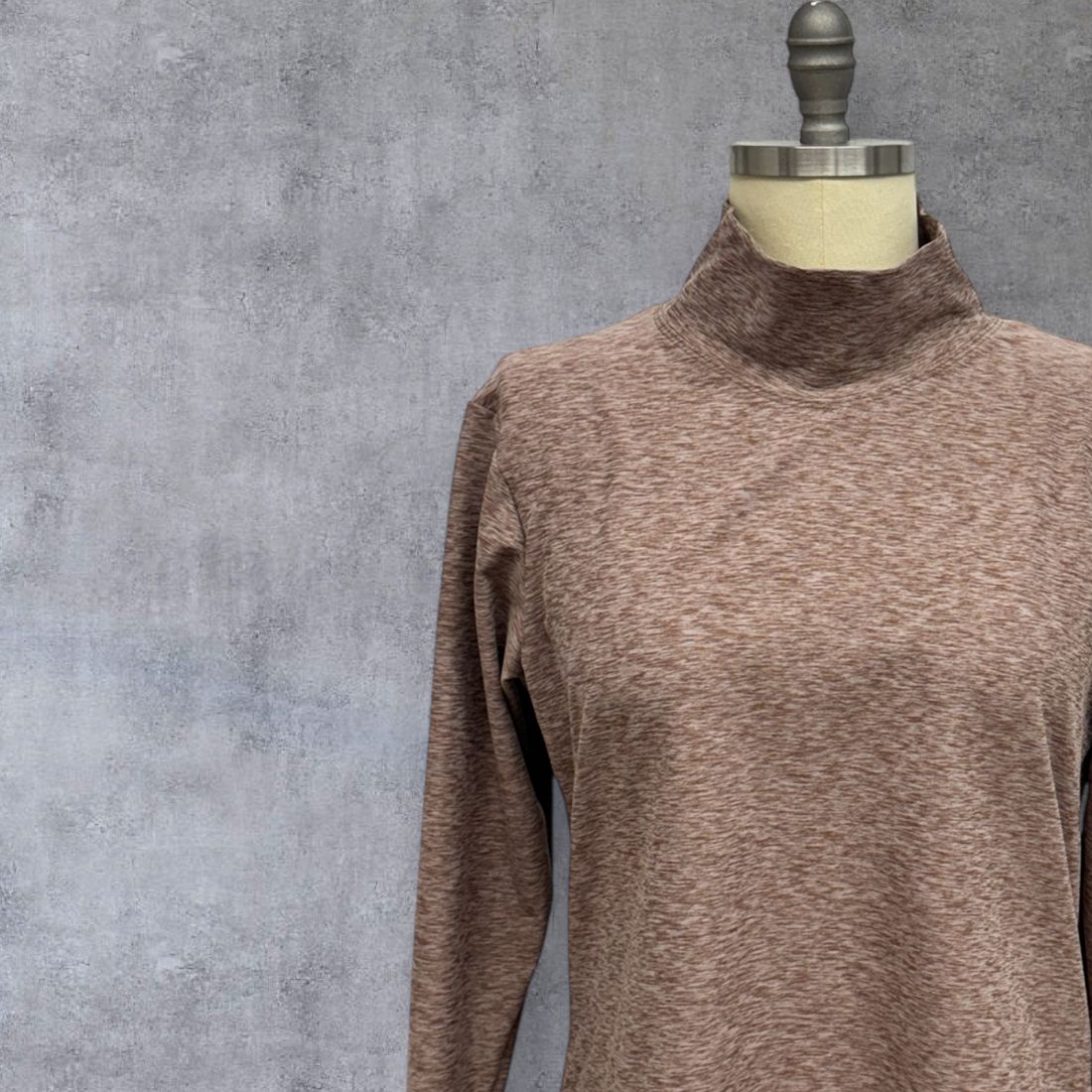 Front view  of clay nomad skivvy showing extra-long sleeves with thumbholes, women’s fit