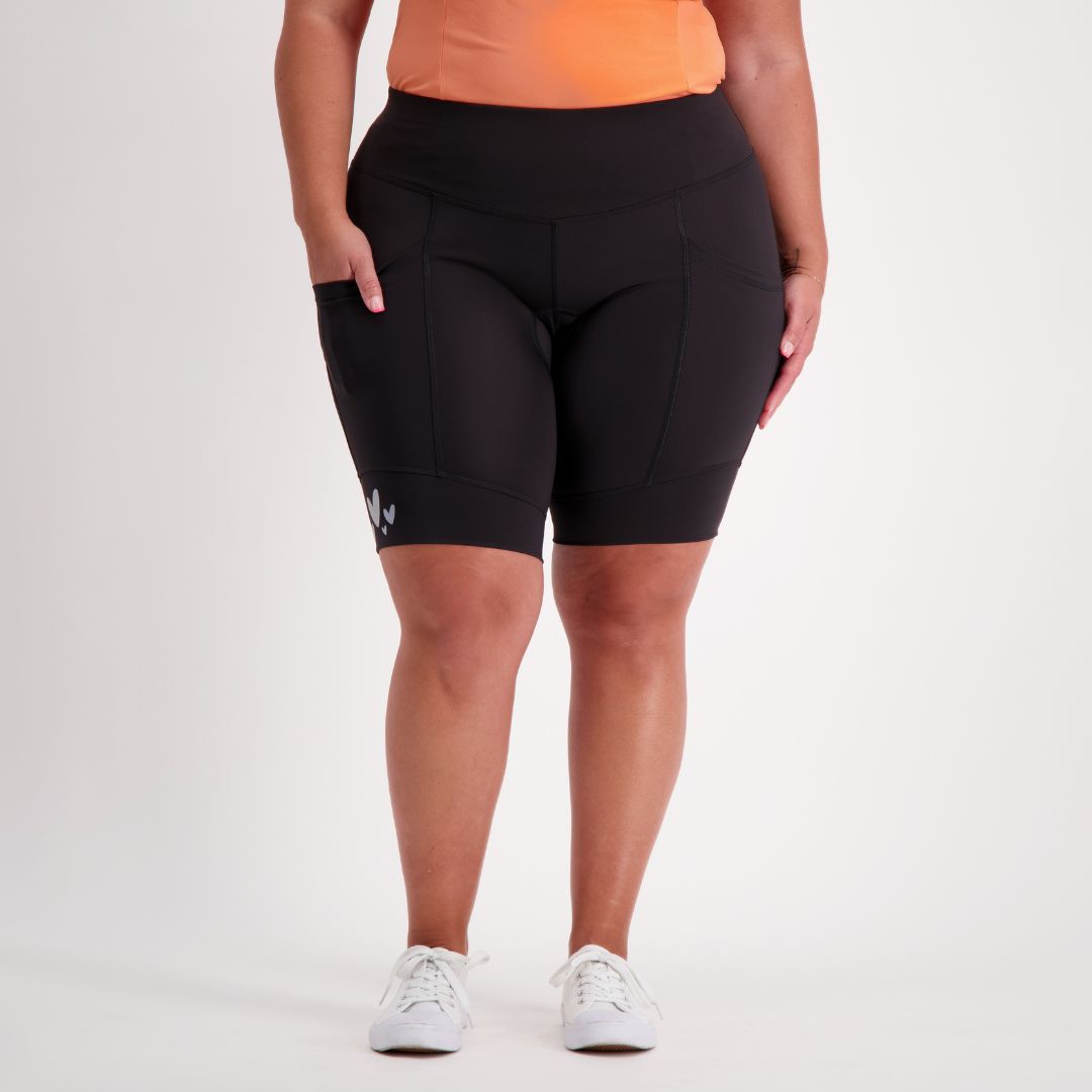 Person wearing black padded cycling shorts on a white background