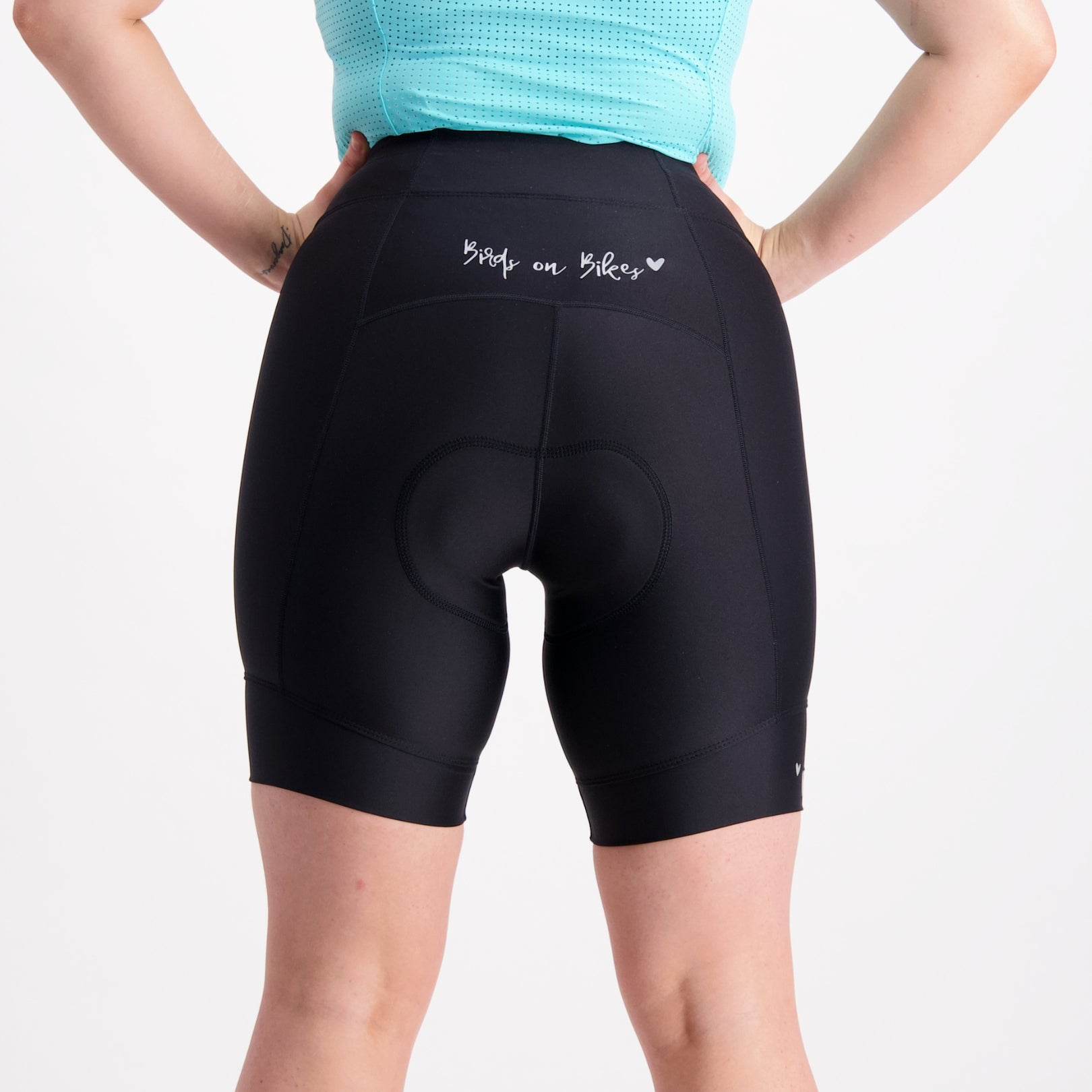 Back view of Birds on Bikes padded bike shorts with a mint blue base layer