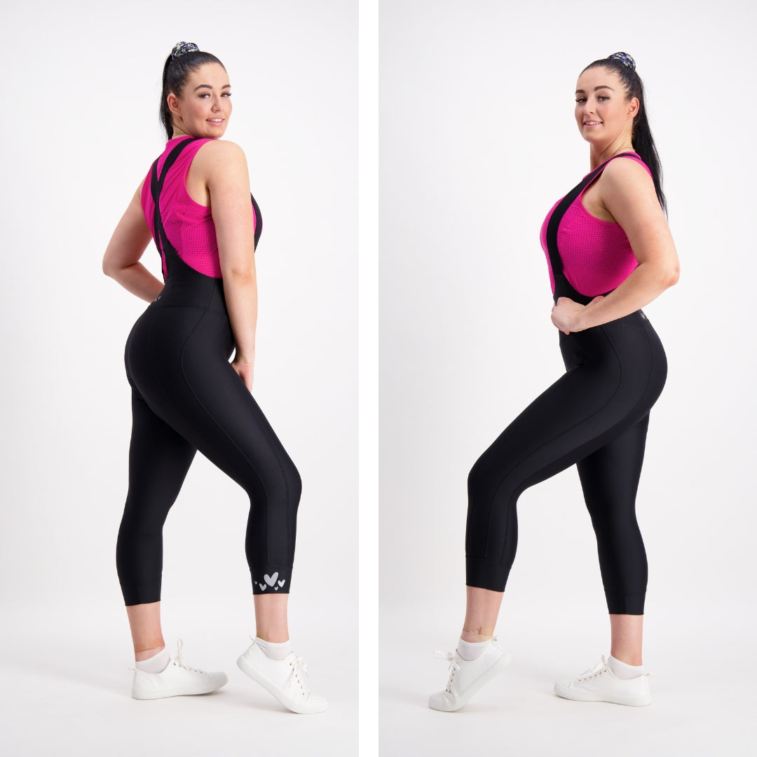 side views of model wearing a pink base layer and capri length black cycling bibs
